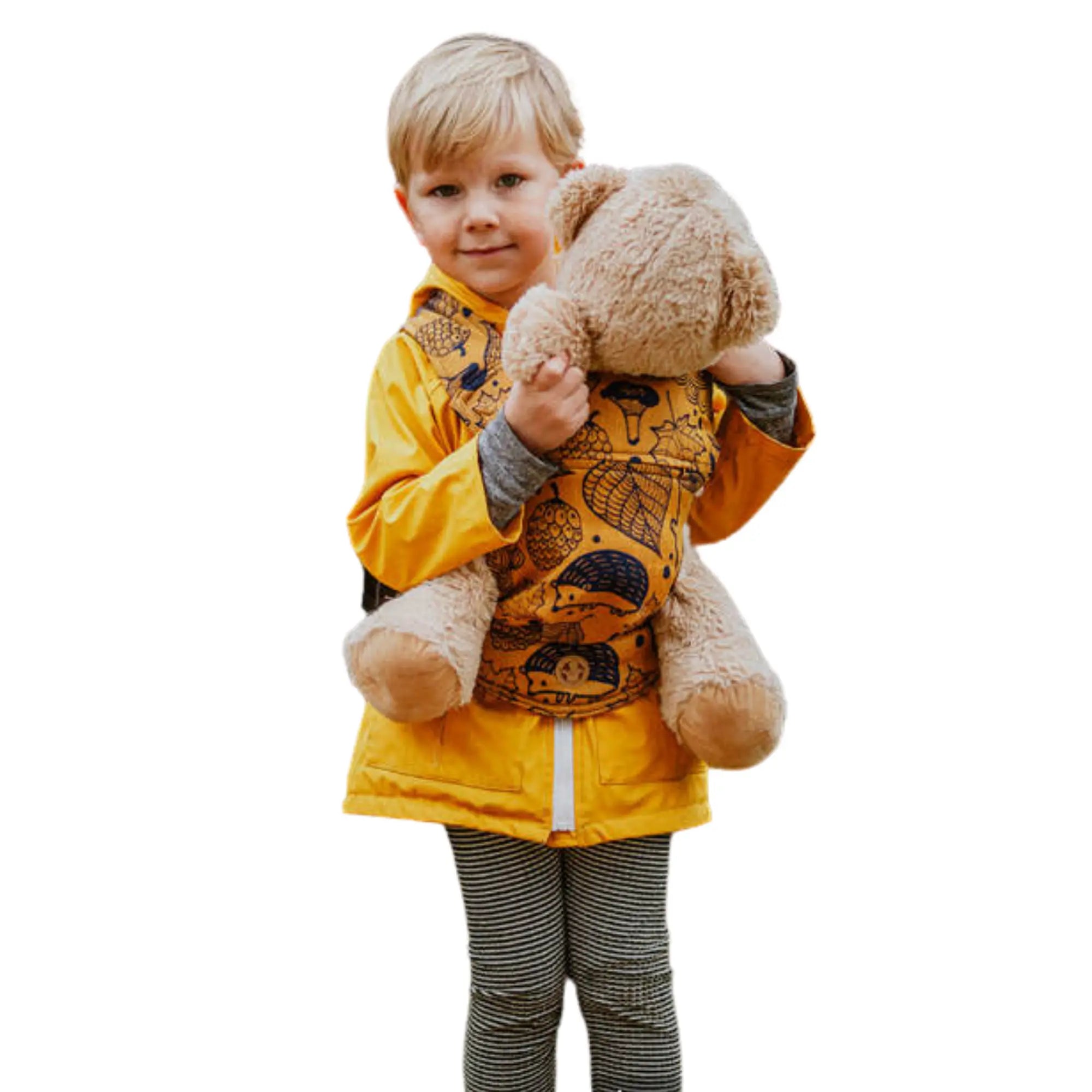Child playing with a bear in a mini doll carrier, mimicking real babywearing for imaginative play and bonding