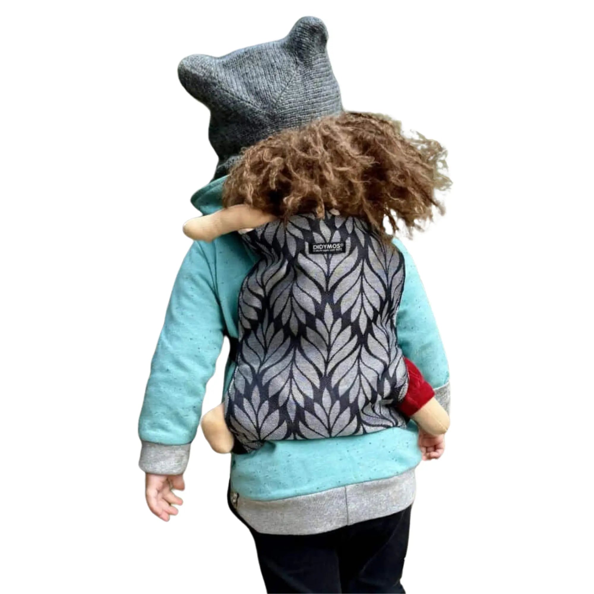 Child playing with a doll in a mini doll carrier, mimicking real babywearing for imaginative play and bonding