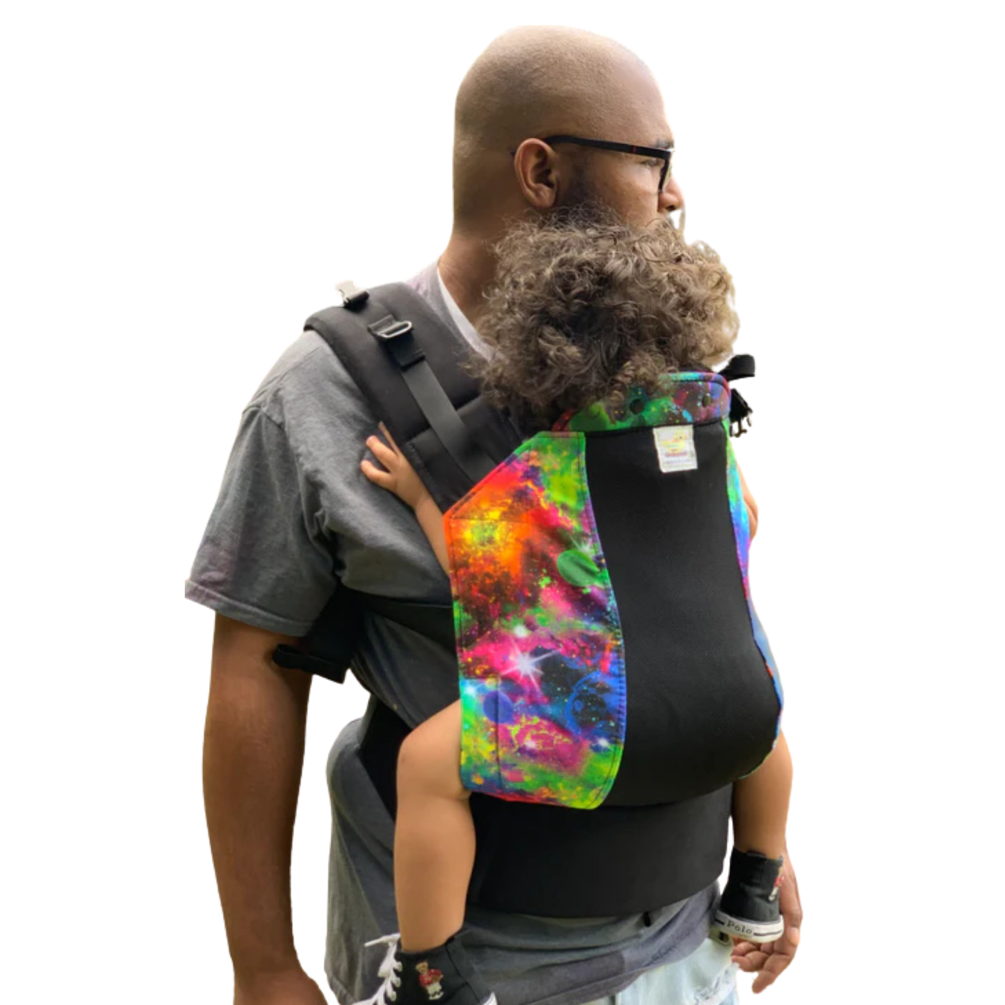 Parent wearing a Kinderpack baby carrier from Little Zen One, showcasing its small-batch, USA-made design in a stylish print.