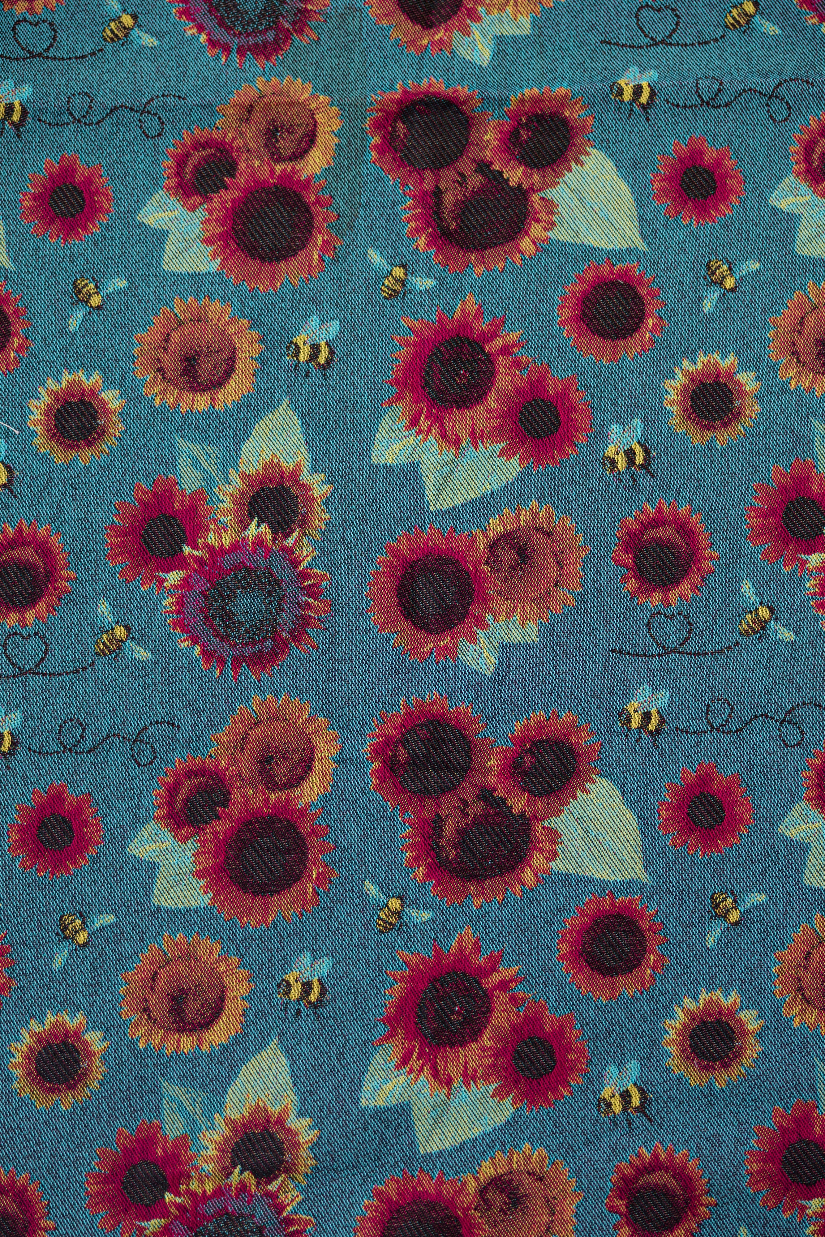 Decorative pattern with stylized figures and foliage and skulls on a orange background