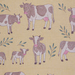 Pattern of cows and calves on a yellow beige background