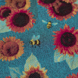 Decorative pattern with sunflowers and bees on a blue background