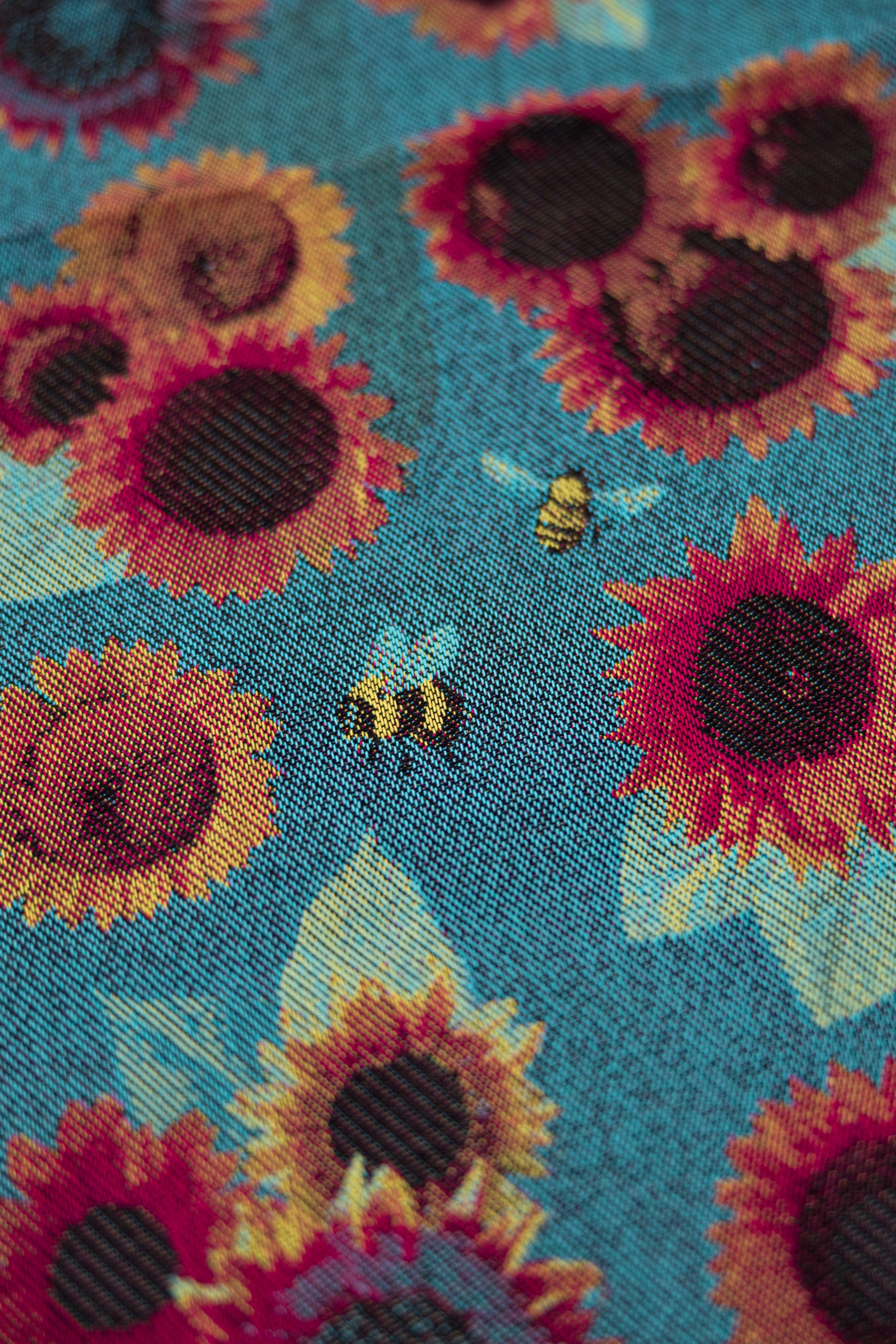 Decorative pattern with sunflowers and bees on a blue background