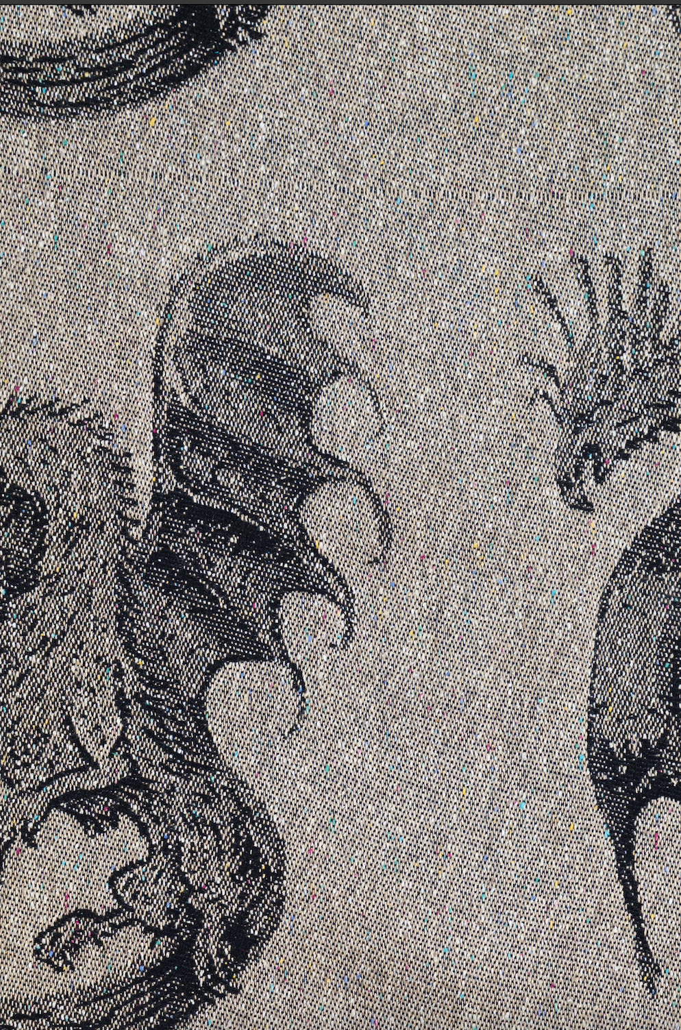 Close-up of a woven textile pattern featuring black and white dragon  antasy creature illustrations on a white background.