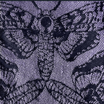 Close-up of a textured fabric with a floral pattern in black on a dark blue background