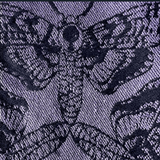 Close-up of a textured fabric with a floral pattern in black on a dark blue background