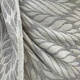 Close-up of textured fabric with a leaf pattern in gray tones
